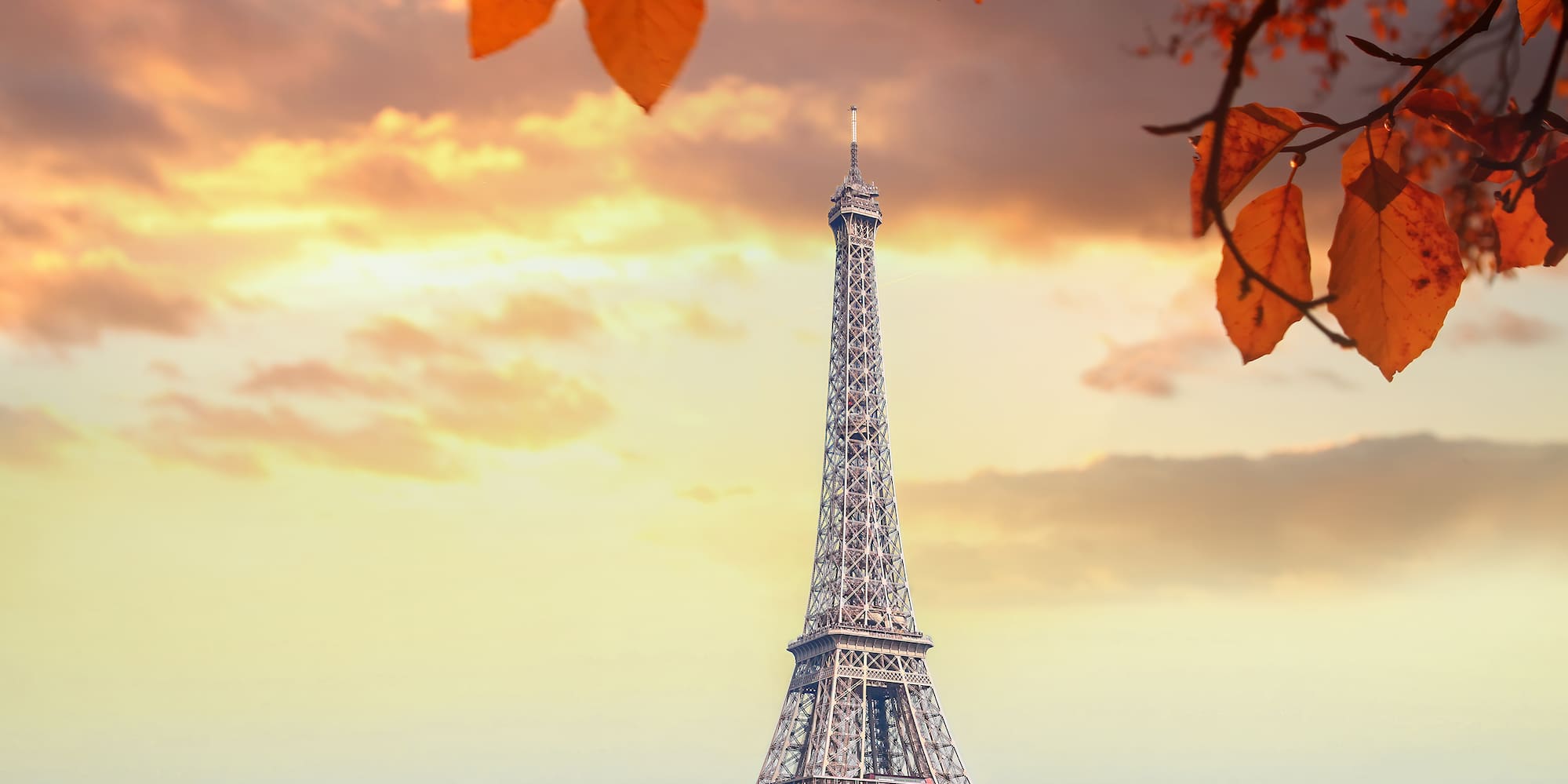 a tower with trees and water in front of it