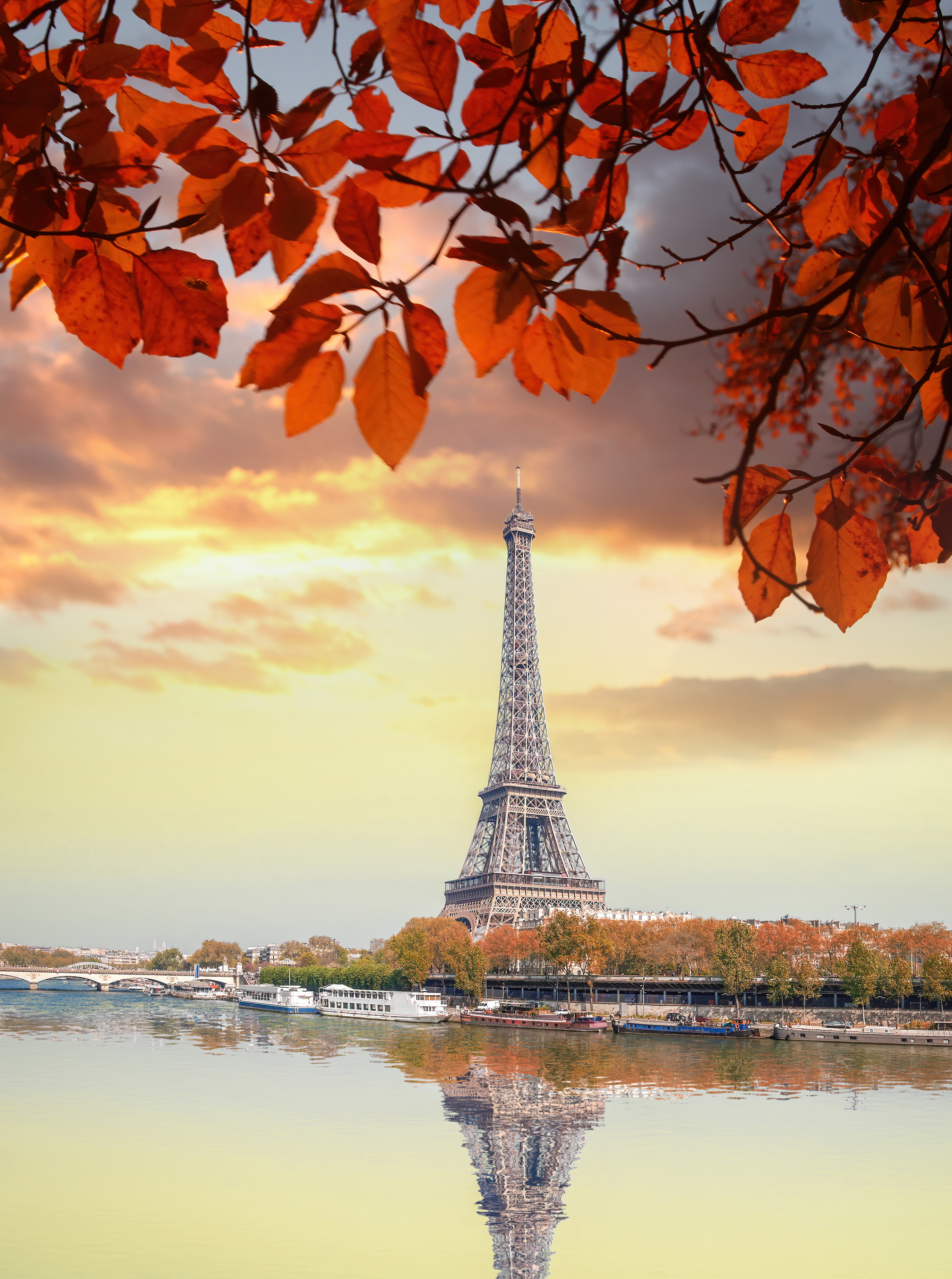 a tower with trees and water in front of it