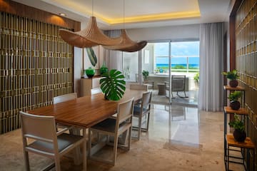 a dining room with a table and chairs