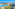 Tropical beachfront resort with pools, waterslides, palm trees, and ocean view.