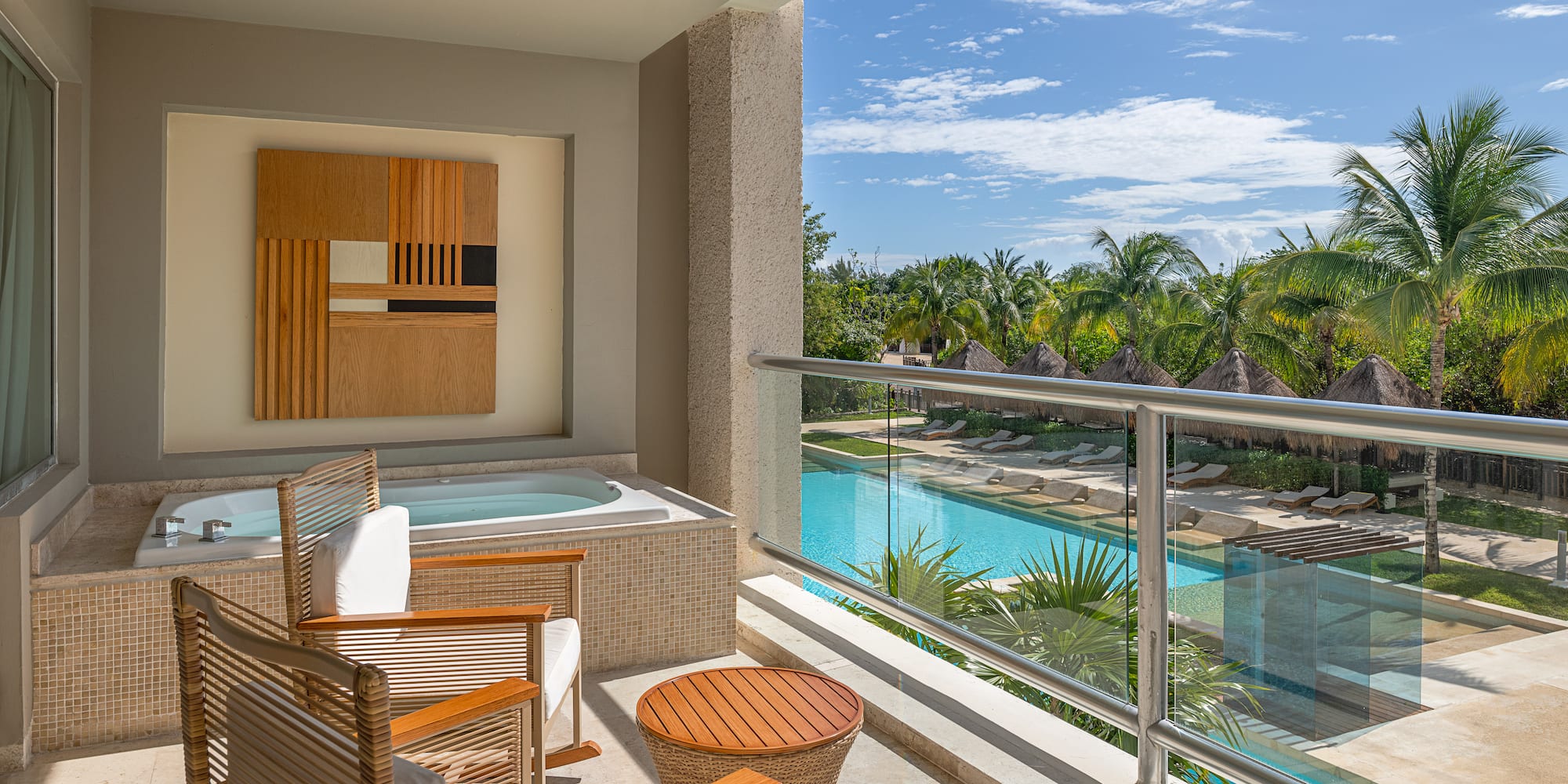 a balcony with a jacuzzi and chairs