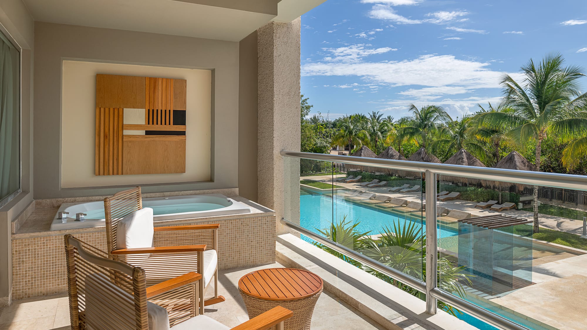 a balcony with a jacuzzi and chairs