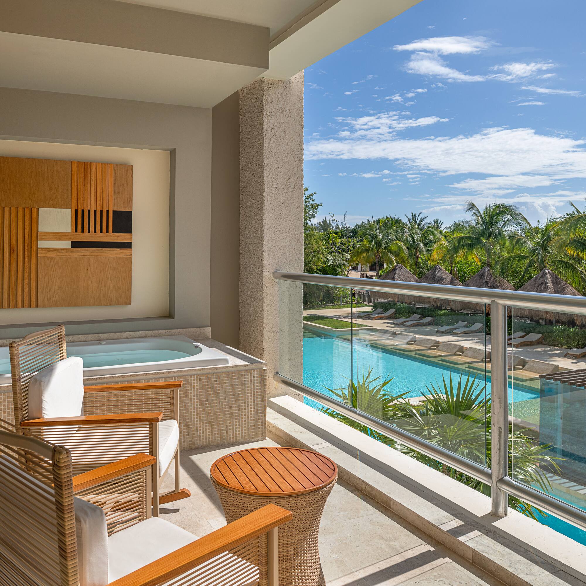 a balcony with a jacuzzi and chairs