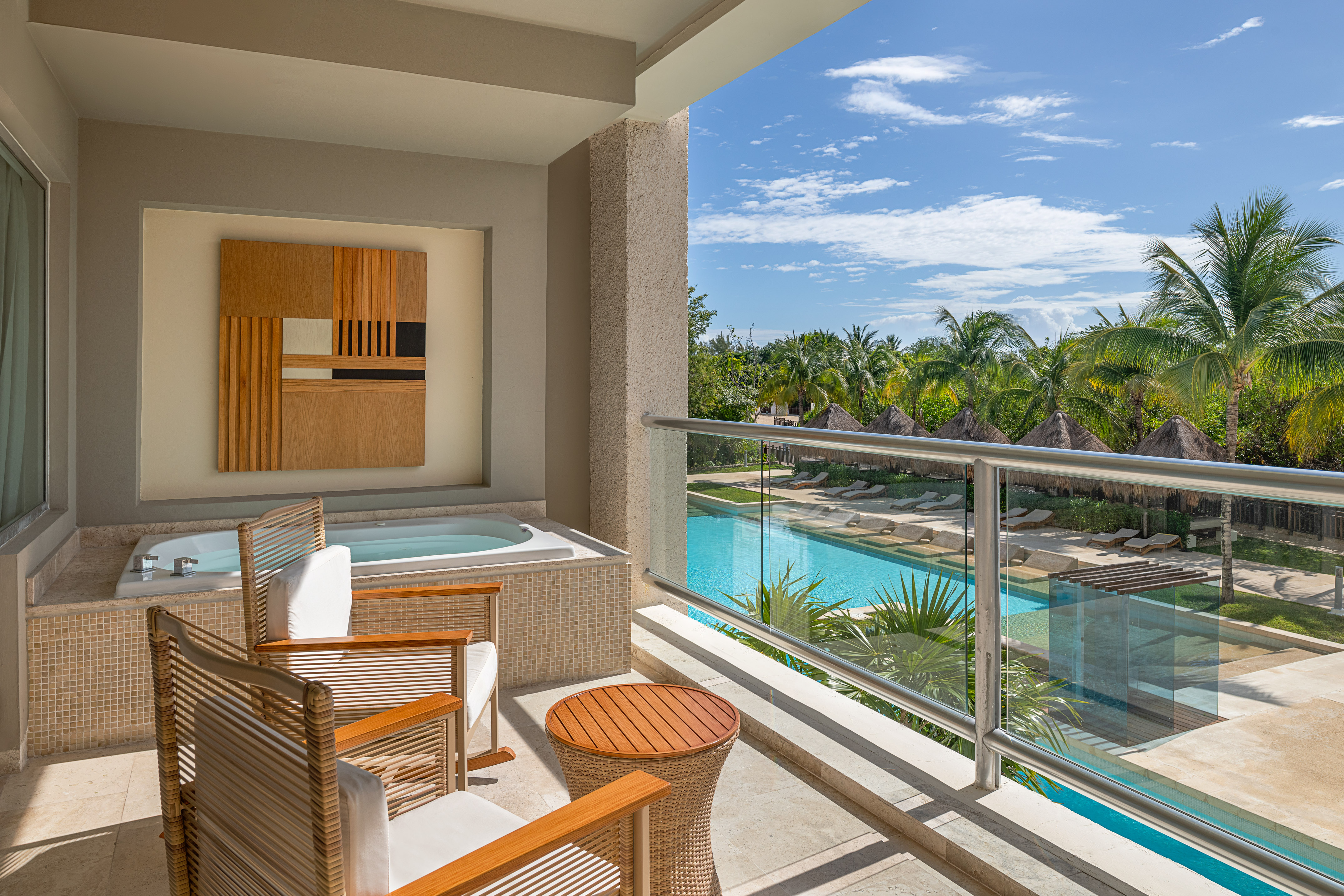 a balcony with a jacuzzi and chairs