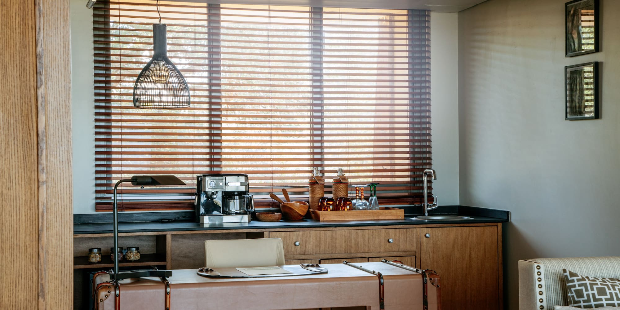 a kitchen with a table and a lamp