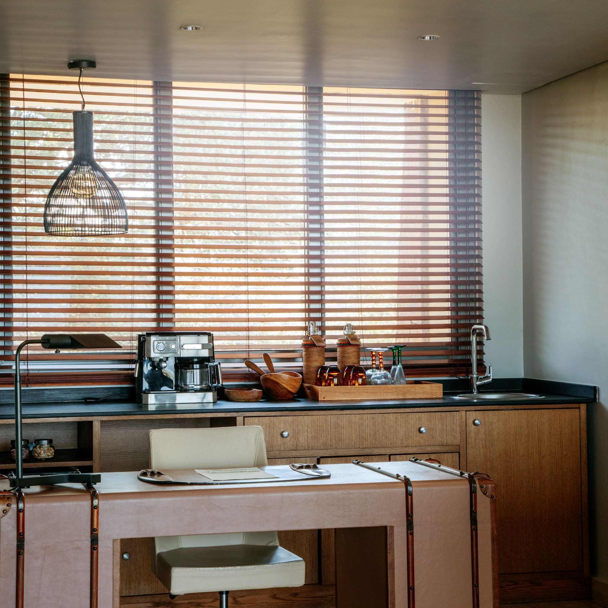 a kitchen with a table and a lamp