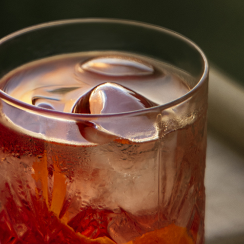 a glass with a drink and ice