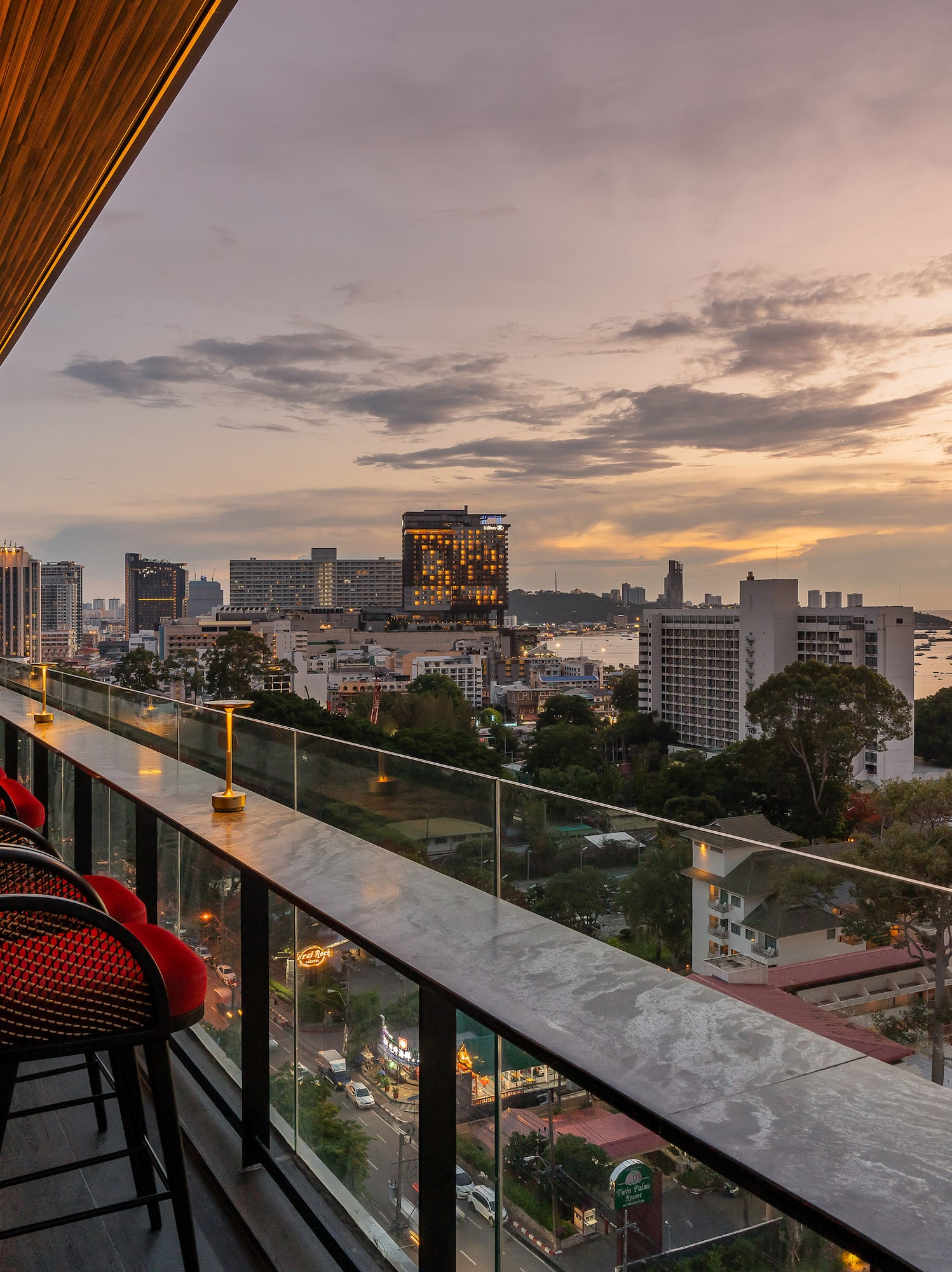 a balcony with chairs and a view of a city