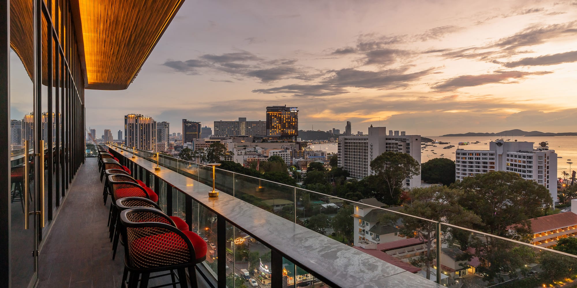 a balcony with chairs and a view of a city