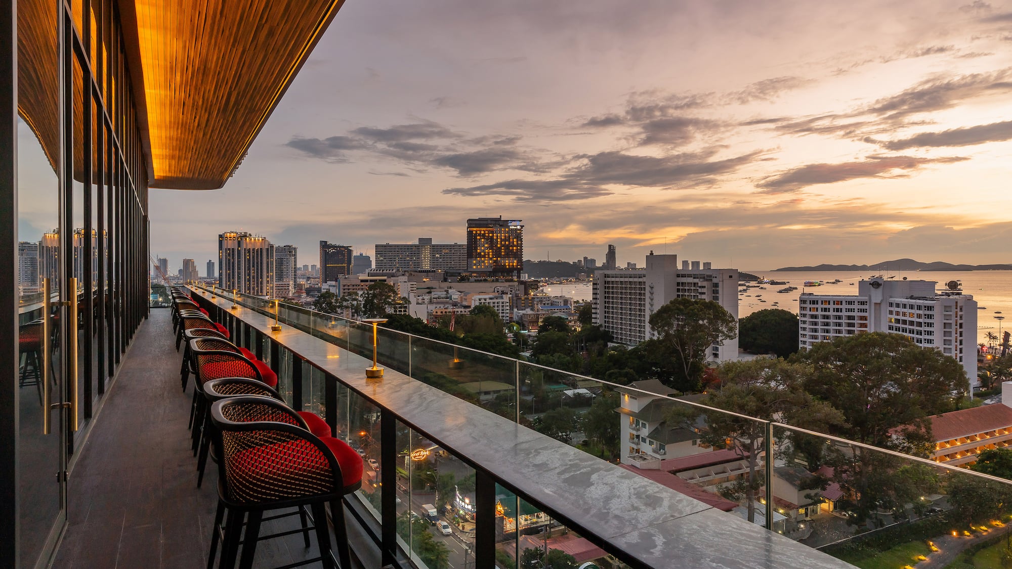 a balcony with chairs and a view of a city