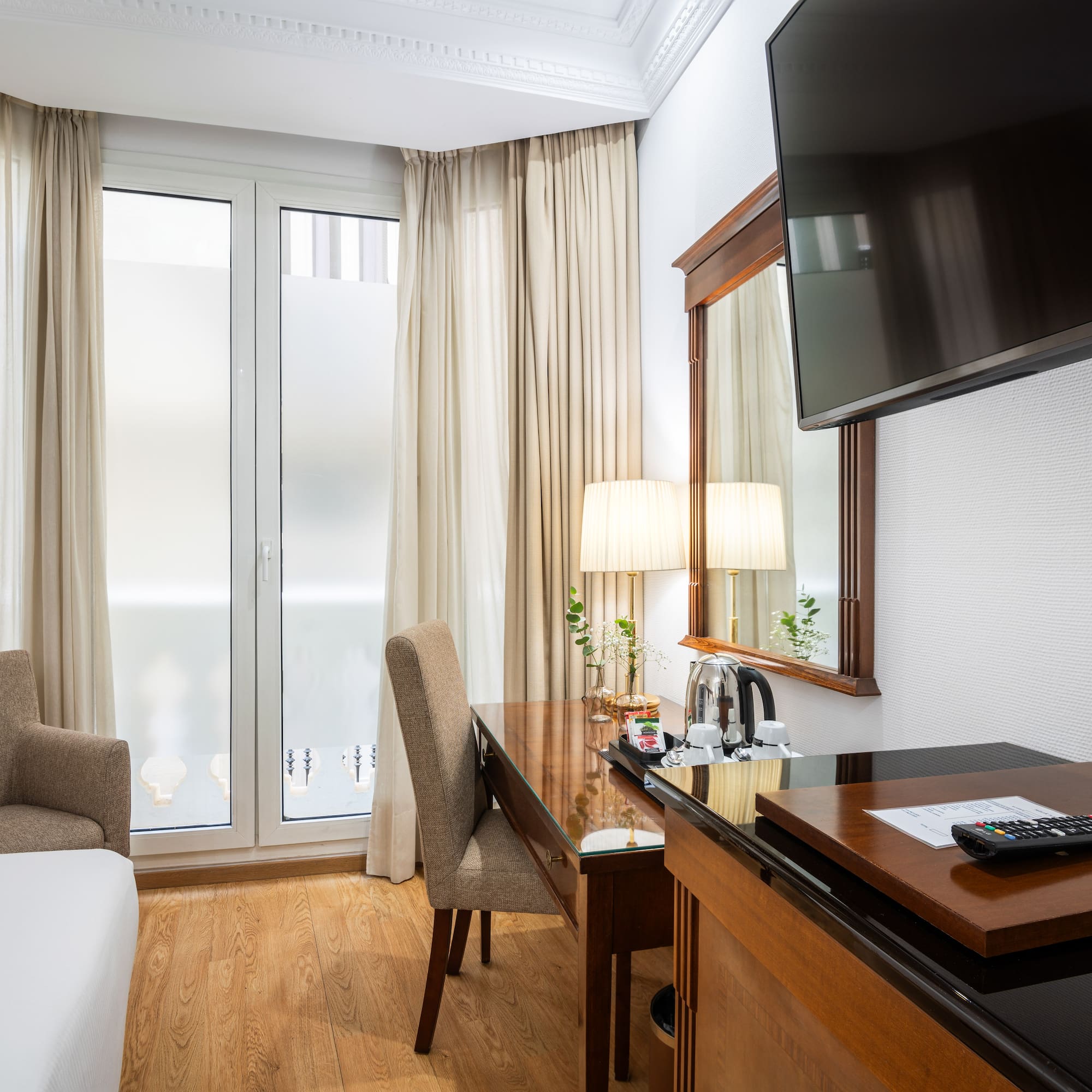 a room with a tv and a desk