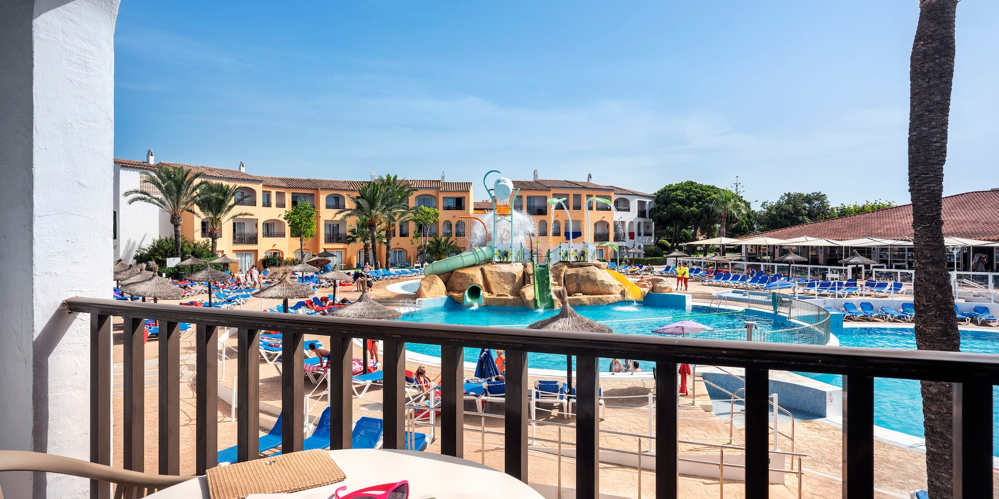 a pool with a table and chairs