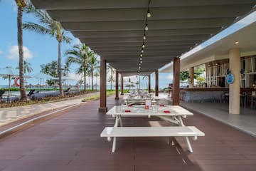 a covered patio with tables and chairs