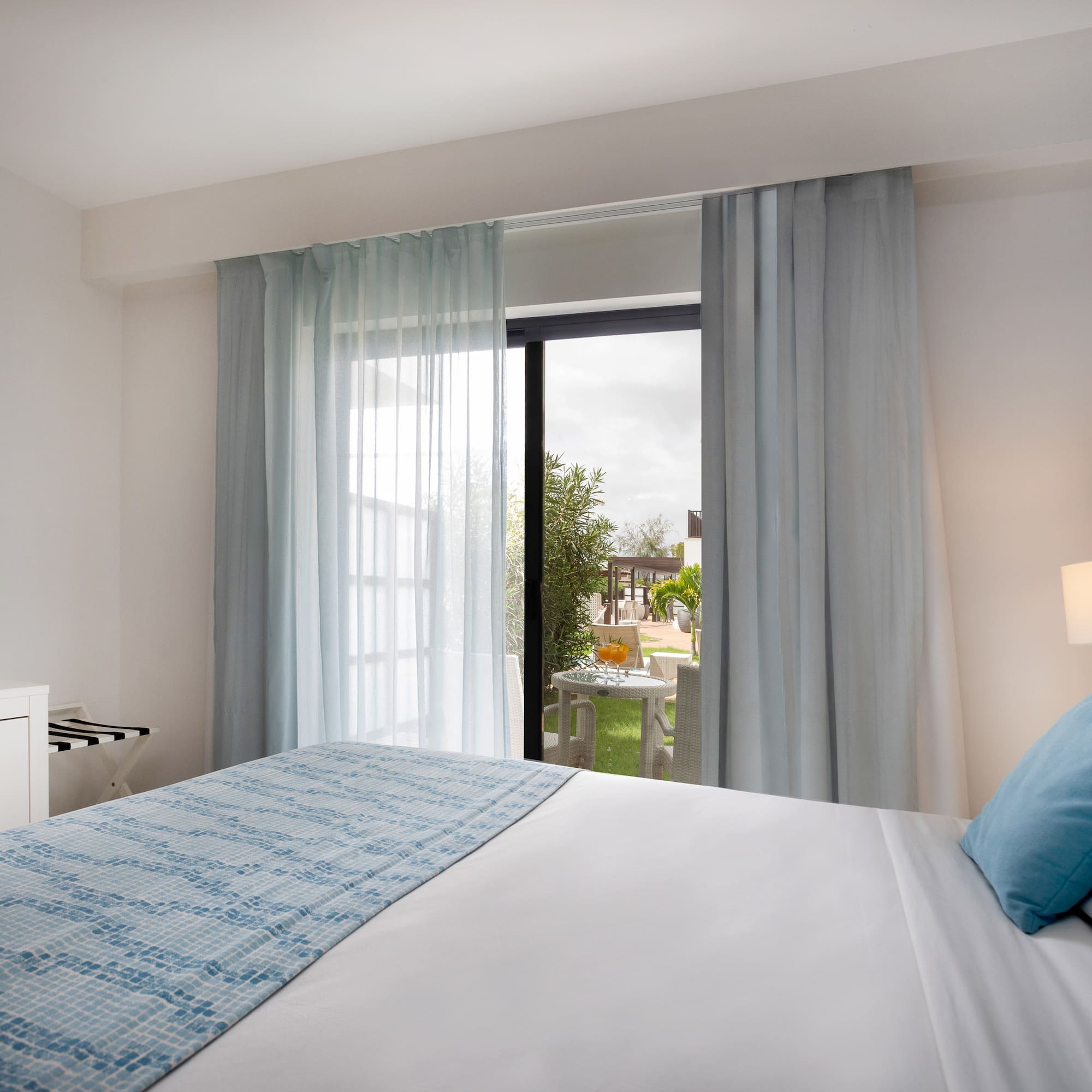 a bed with a lamp and a table with a piano keyboard