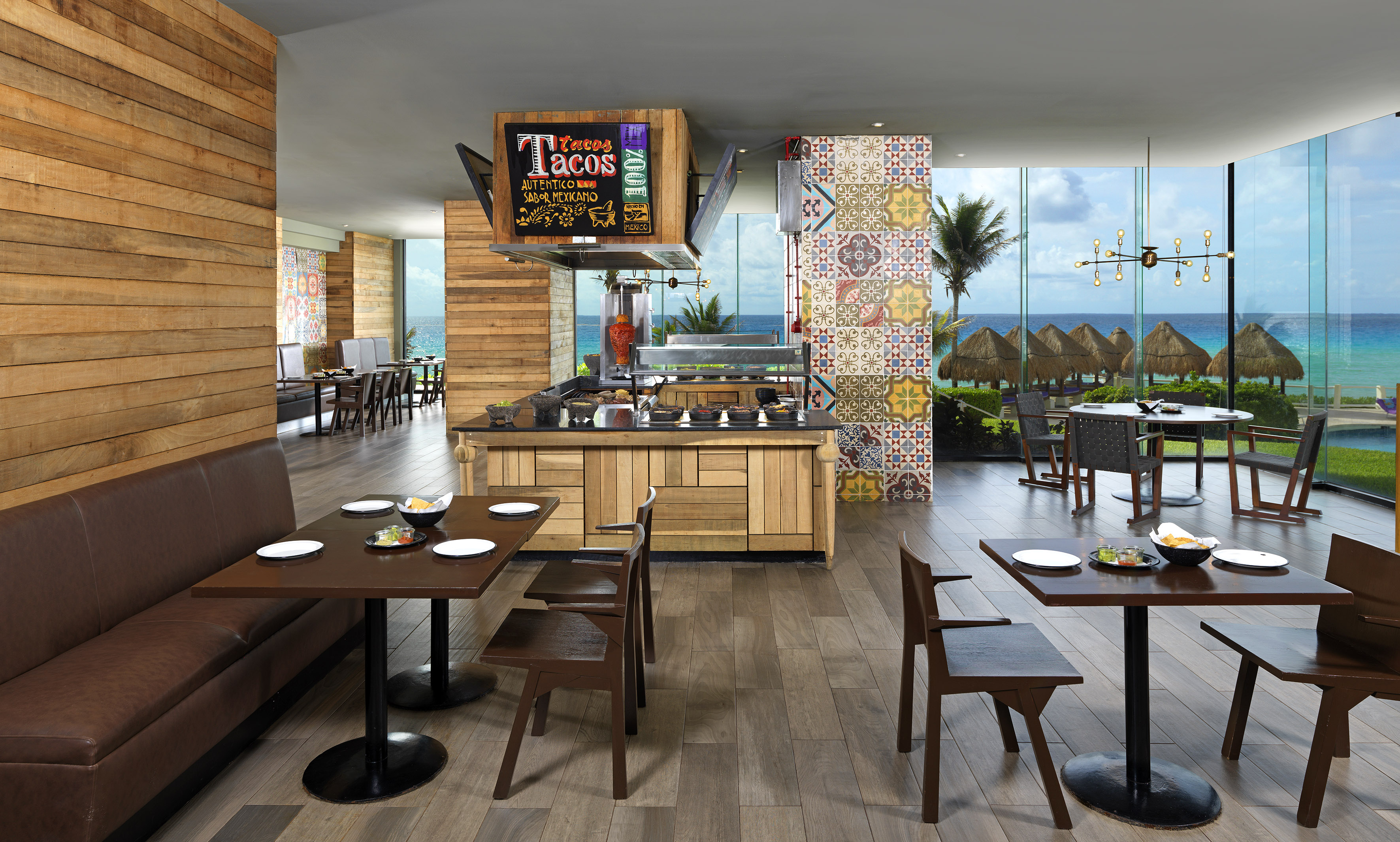 Taco restaurant with ocean view, vibrant tiles, and wood accents.