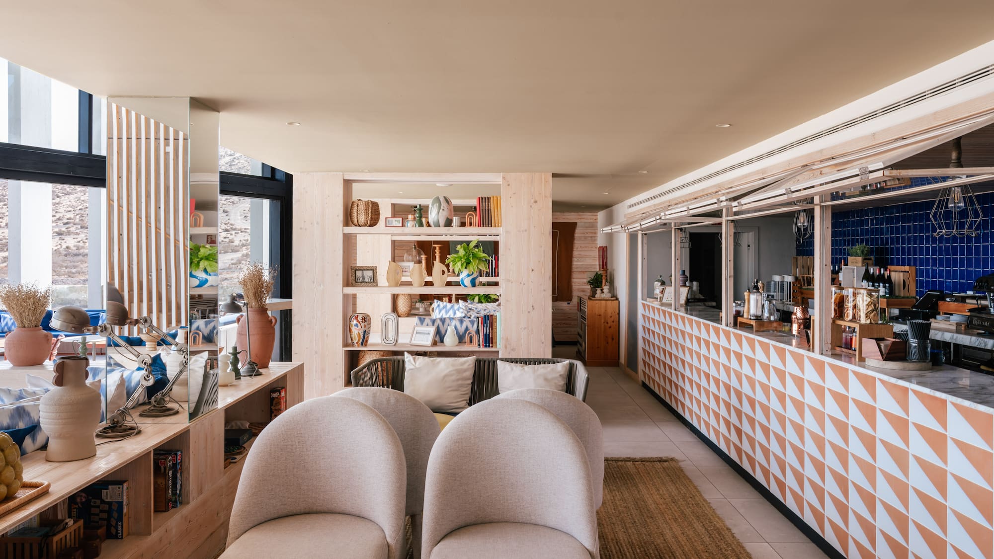 Stylish resort lounge interior with geometric bar and comfortable seating.