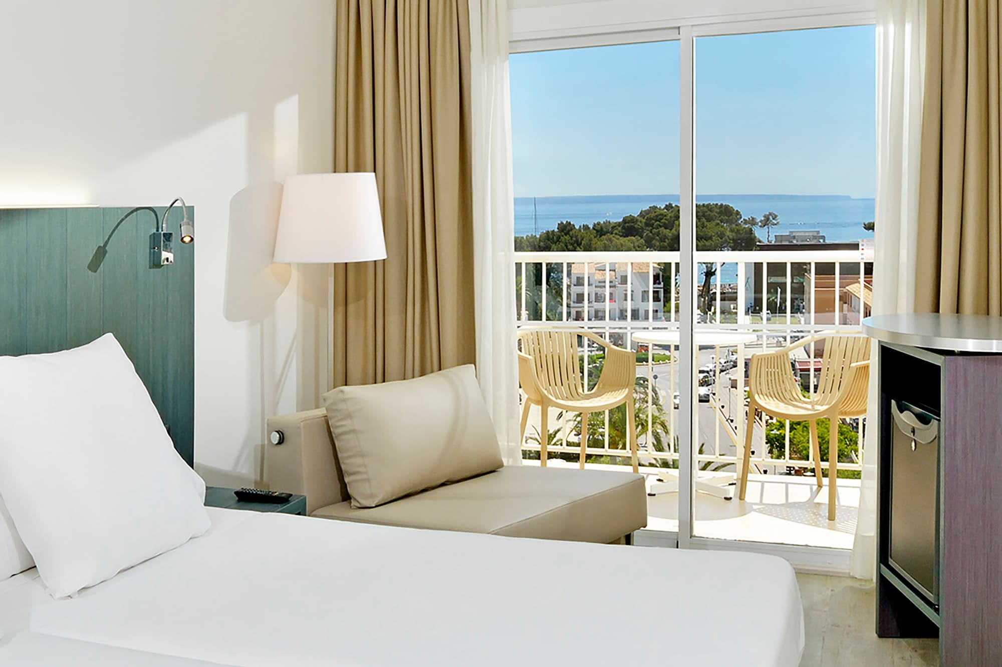 a room with a balcony and a bed