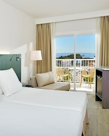 a room with a balcony and a bed