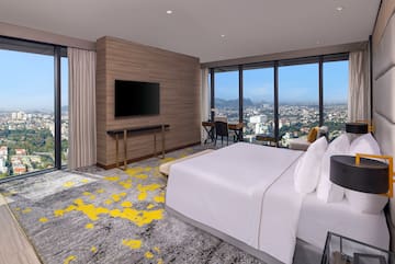 a room with a large window and a large bed
