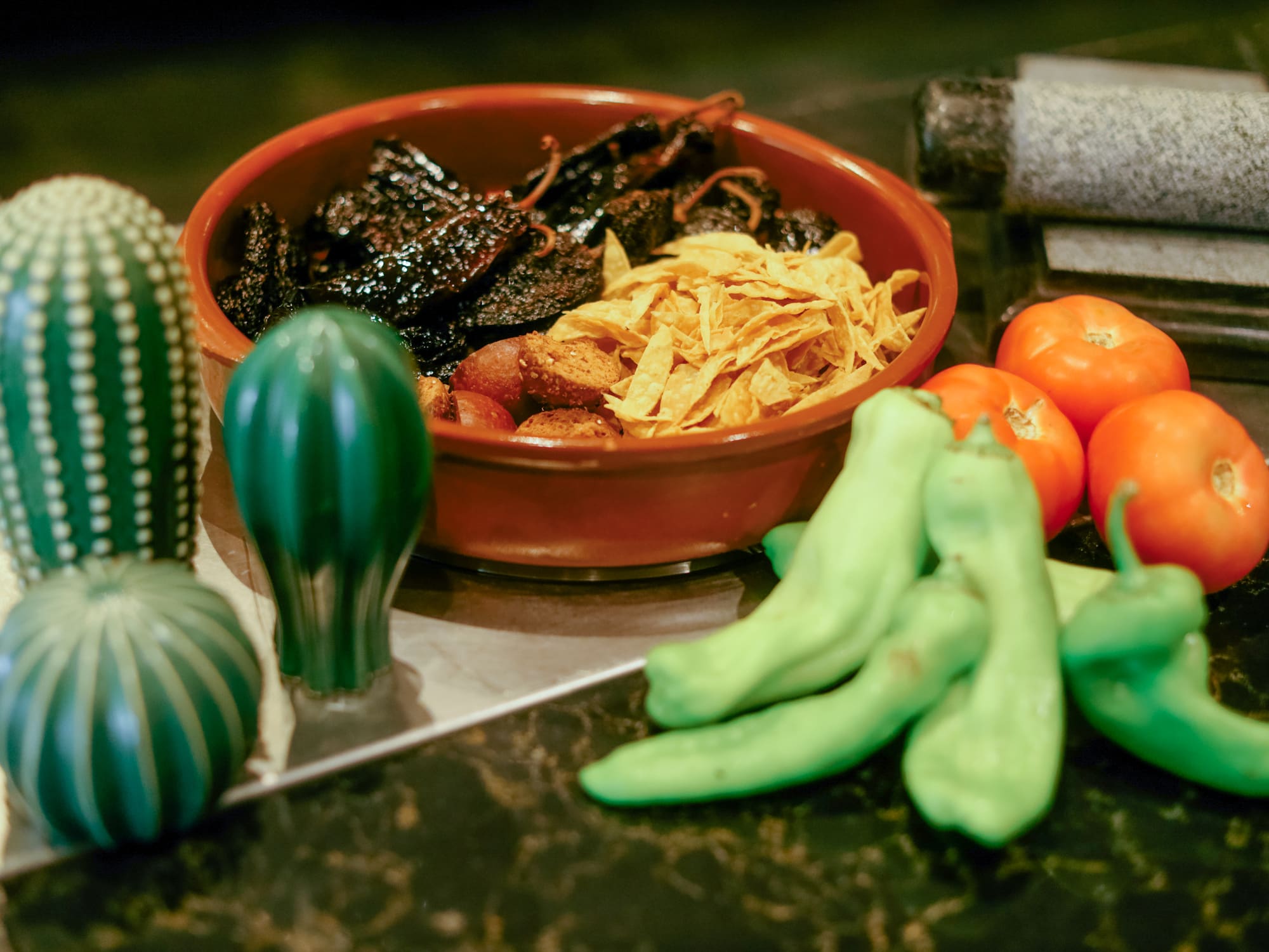 a bowl of food next to vegetables