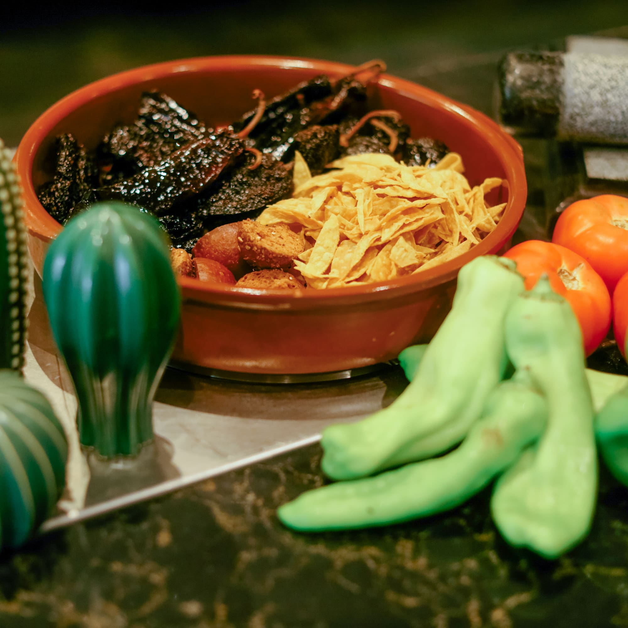a bowl of food next to vegetables