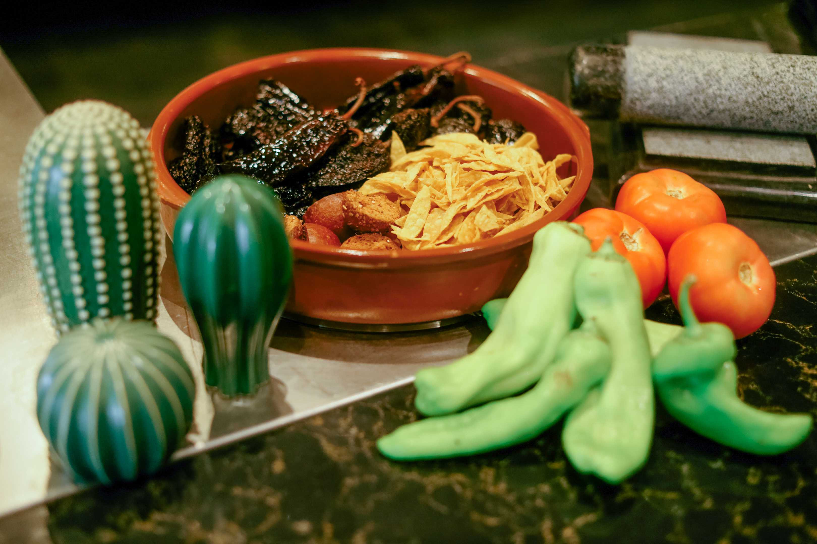 a bowl of food next to vegetables