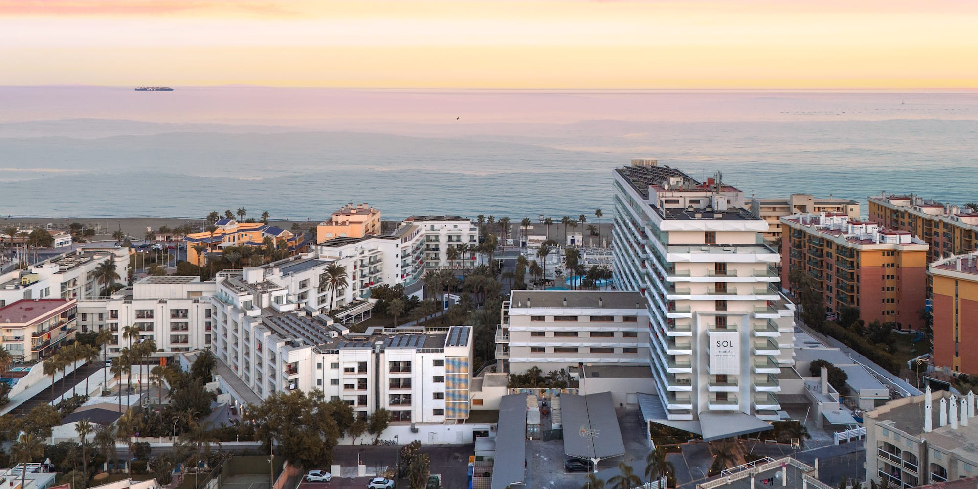a group of buildings next to the ocean