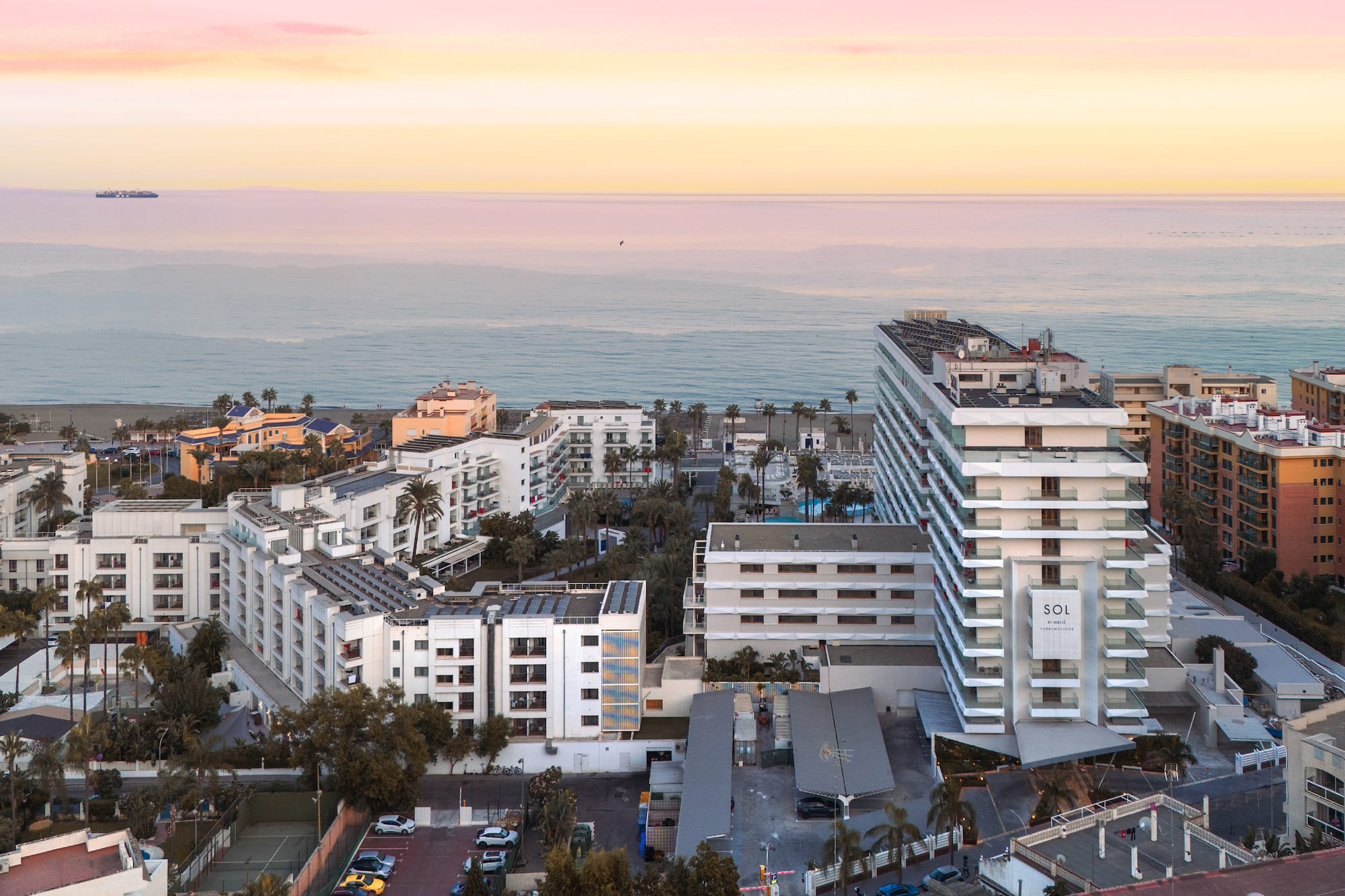 a group of buildings next to the ocean