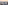 Oceanfront city with modern buildings, beach, and colorful sunset sky.