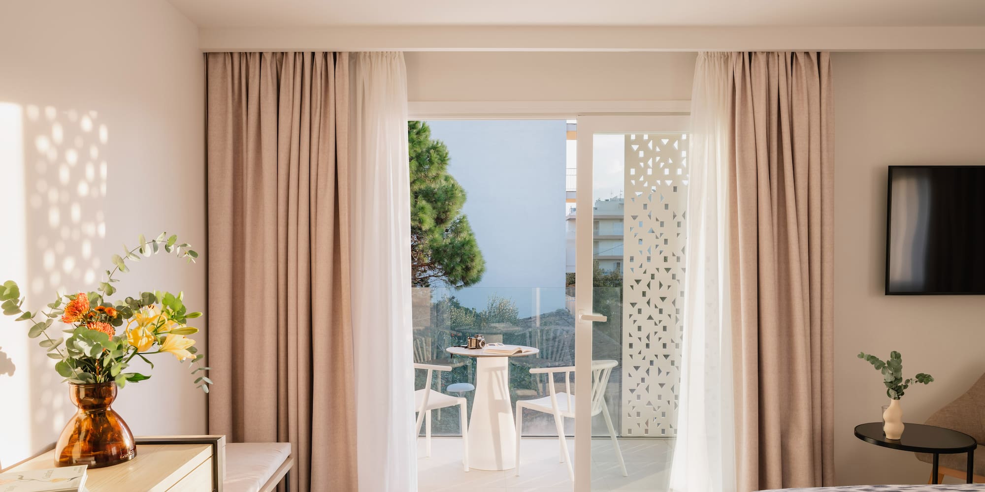 a room with a bed and a table and chairs