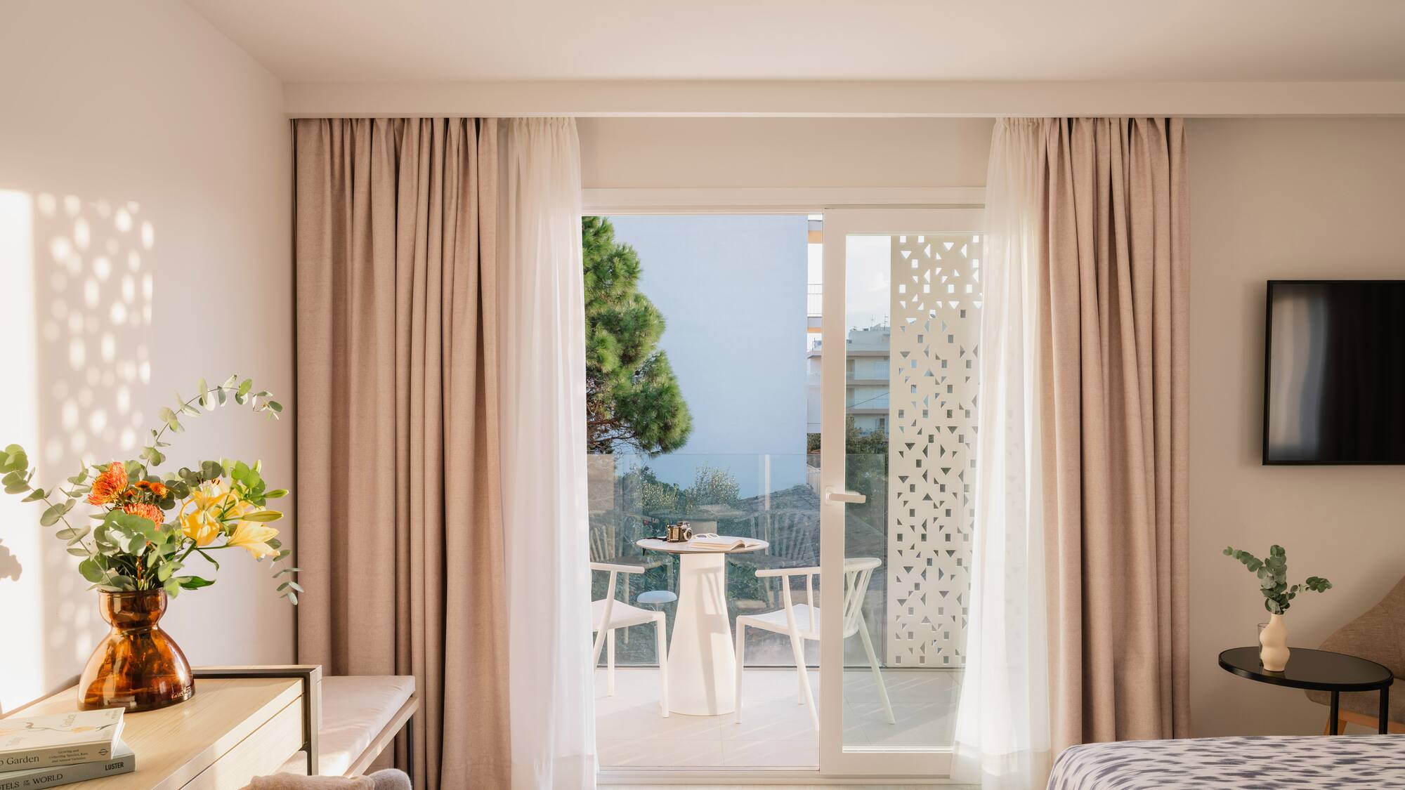 a room with a bed and a table and chairs