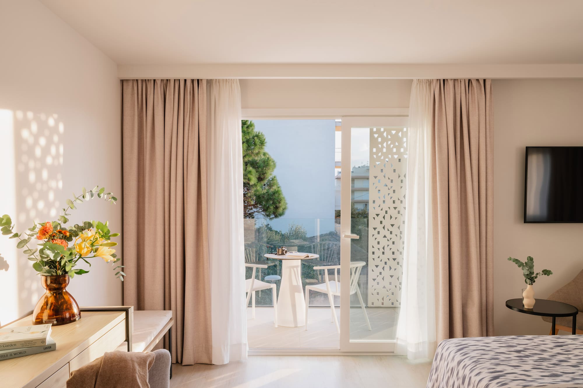 a room with a bed and a table and chairs