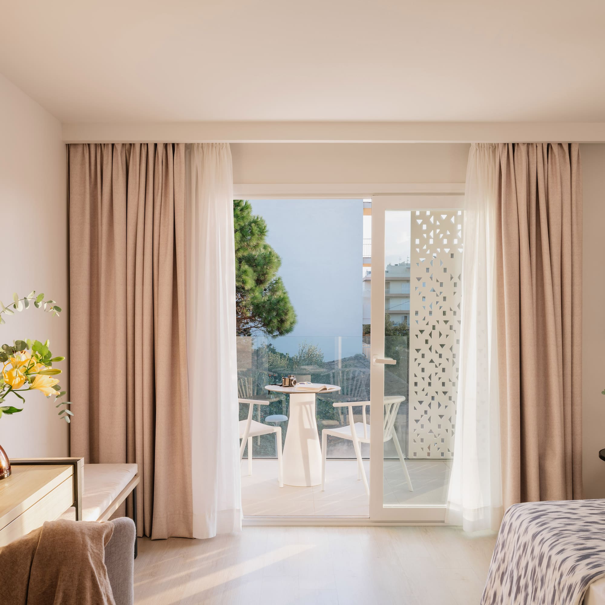 a room with a bed and a table and chairs