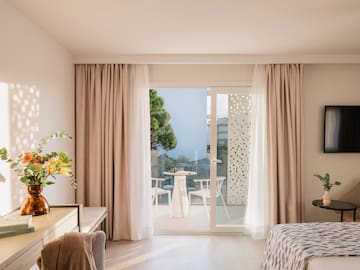 a room with a bed and a table and chairs