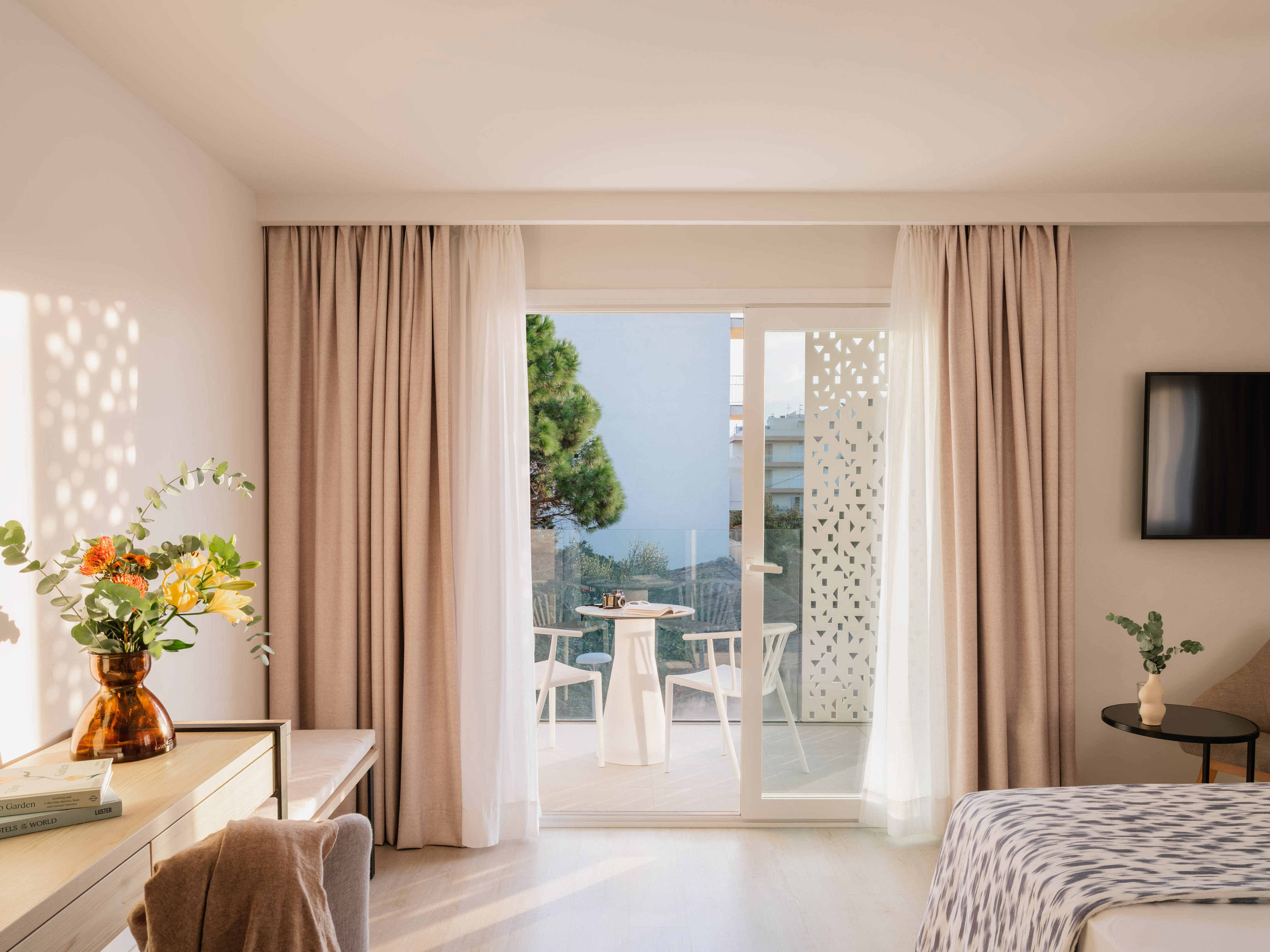 a room with a bed and a table and chairs