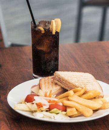 a plate of food and a drink on a table