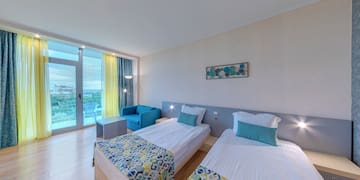 a room with two beds and a table