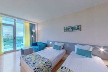 a room with two beds and a table