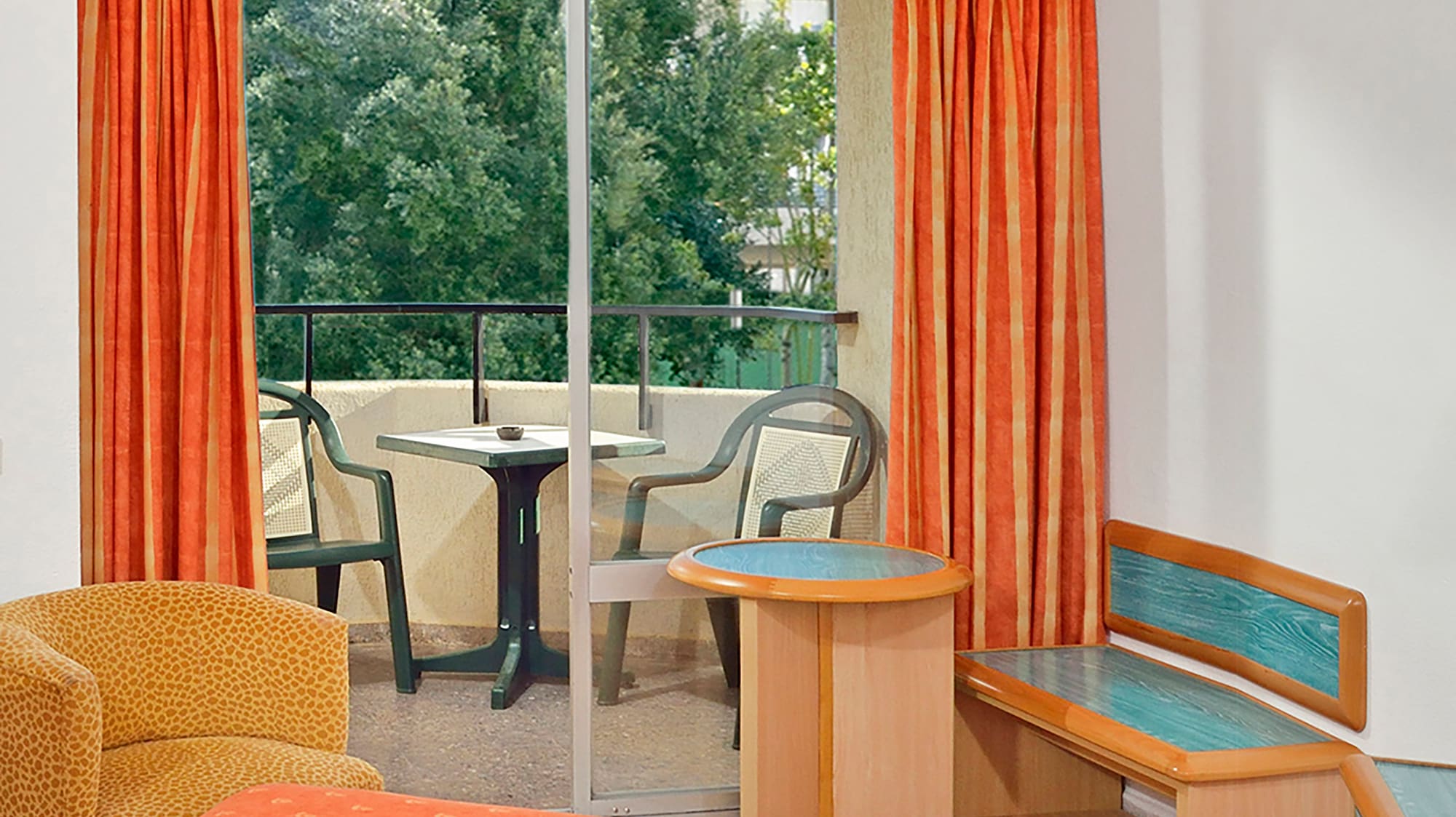 a room with orange curtains and a bed