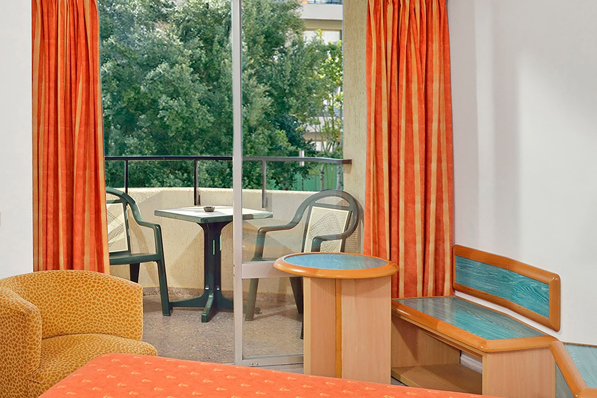 a room with orange curtains and a bed