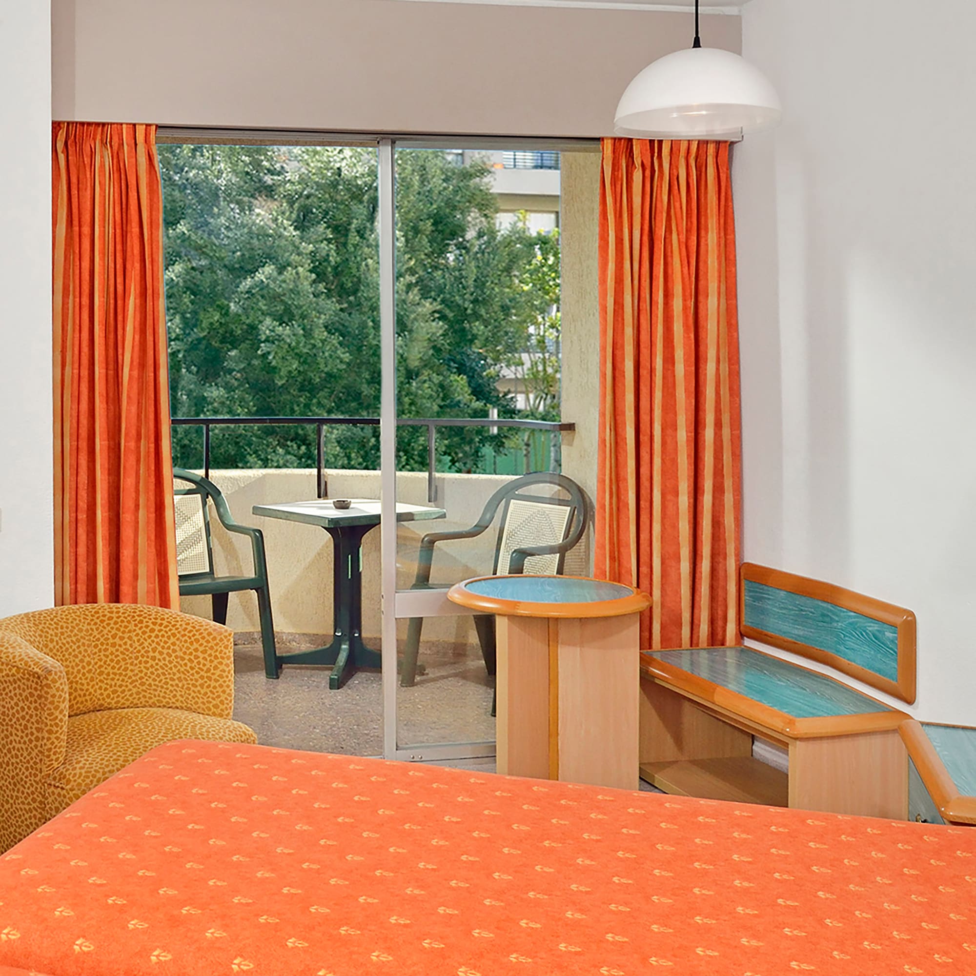 a room with orange curtains and a bed