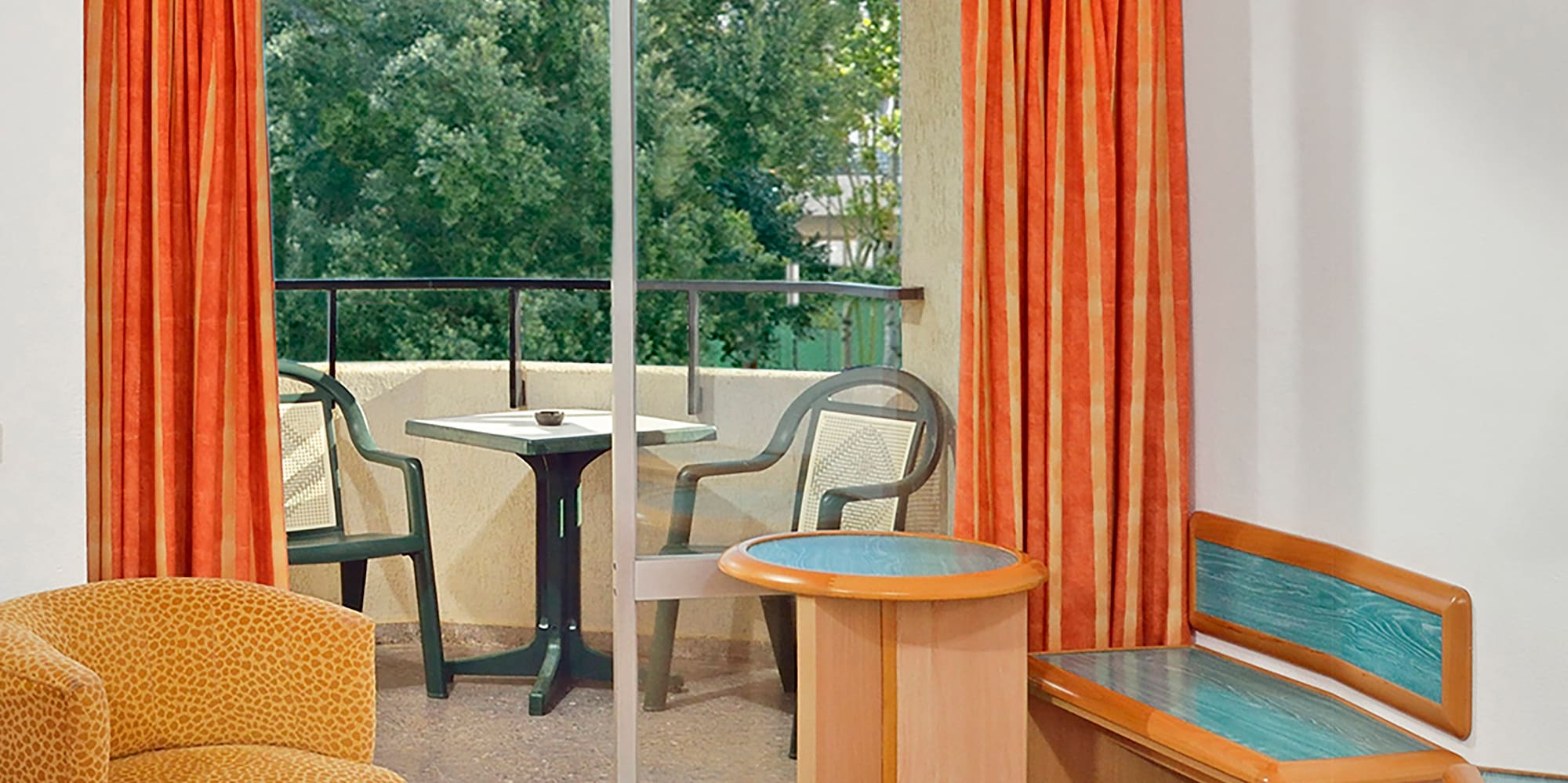 a room with orange curtains and a bed