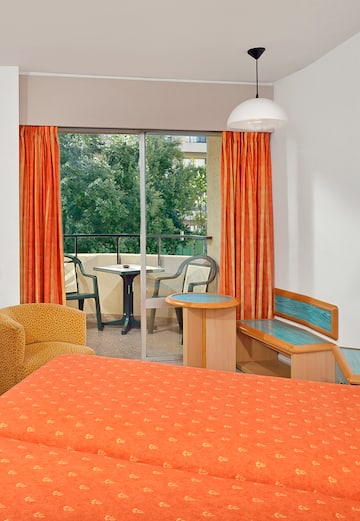 a room with orange curtains and a bed