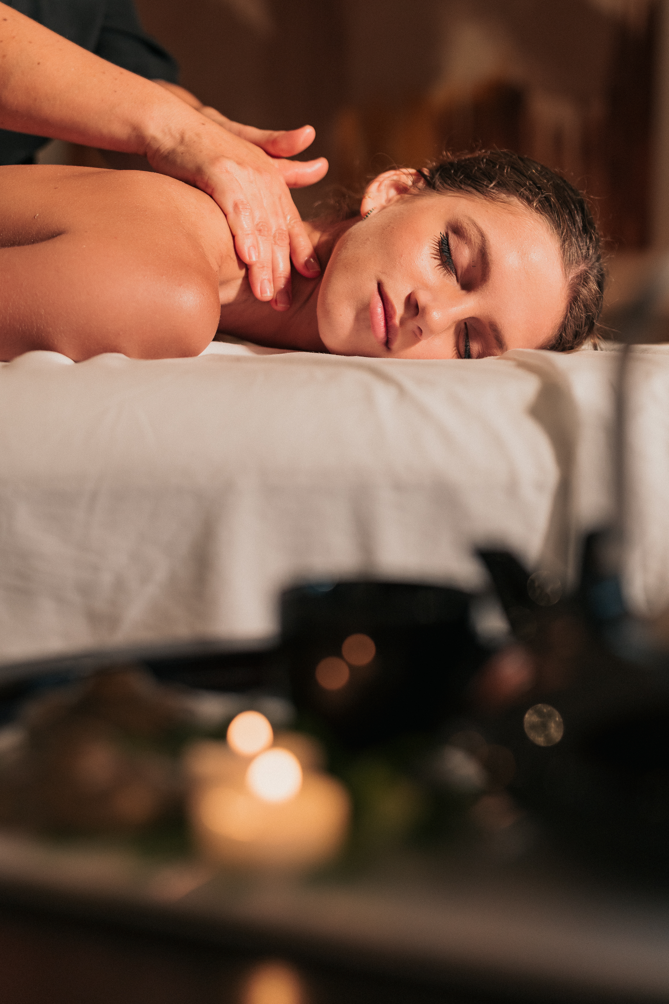 Woman receiving relaxing shoulder massage in a spa.