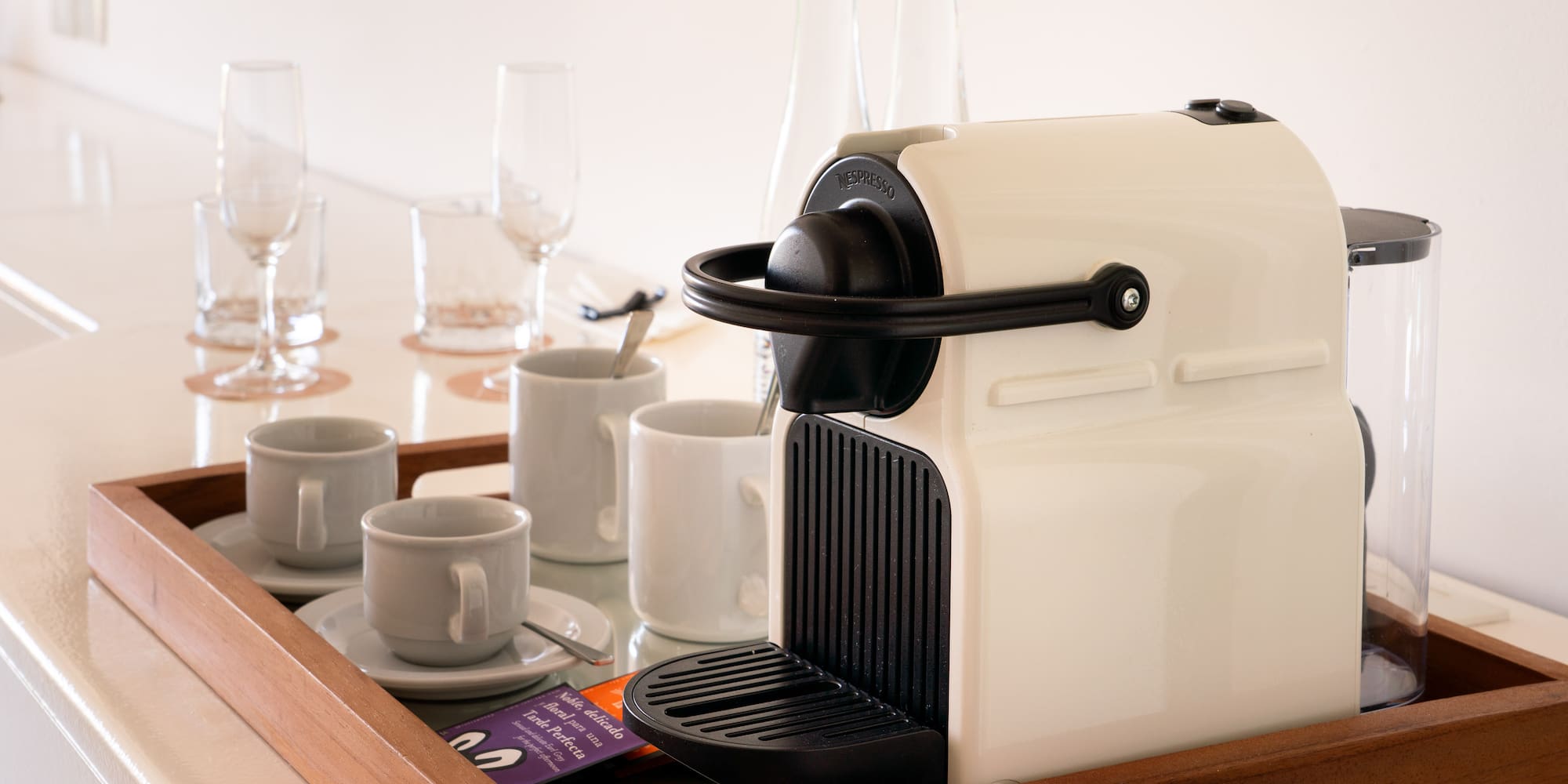 a coffee machine and cups on a tray