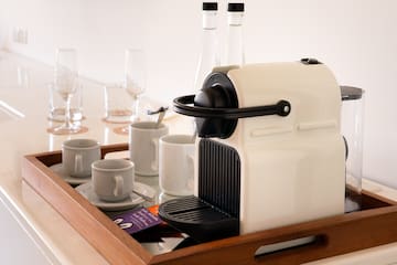 a coffee machine and cups on a tray