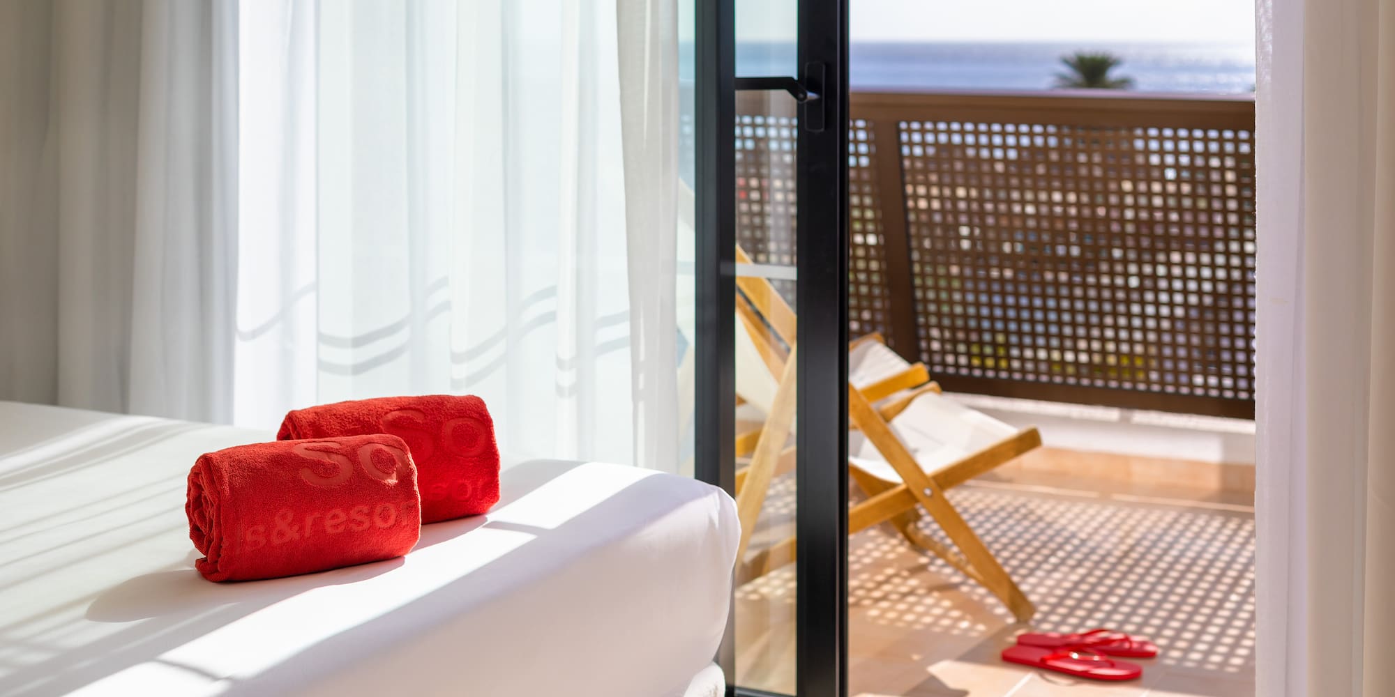 a white couch with red towels on it