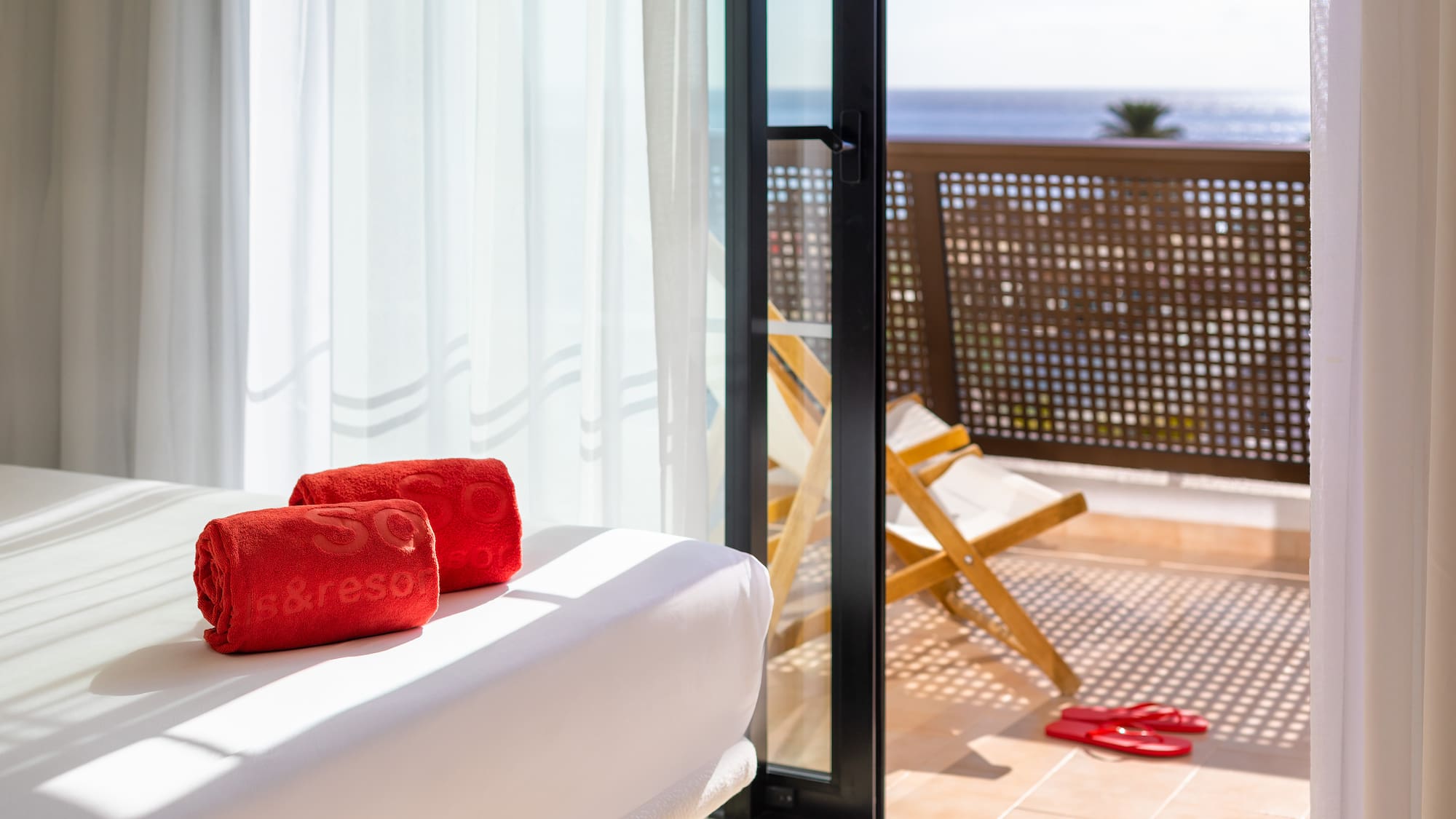 a white couch with red towels on it