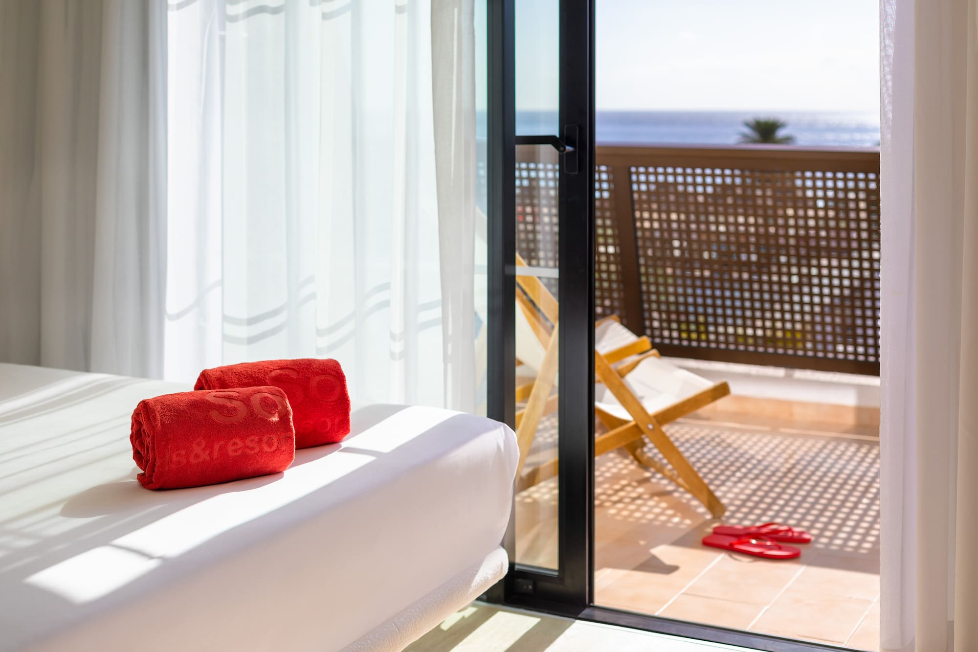 a white couch with red towels on it