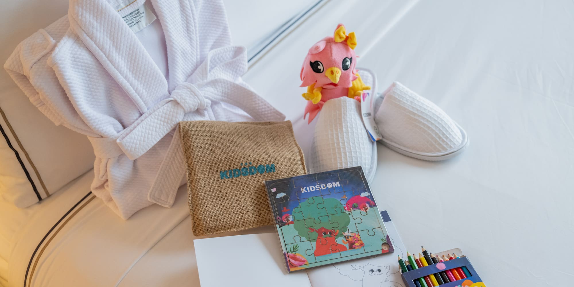 a white robe and a book and a stuffed animal